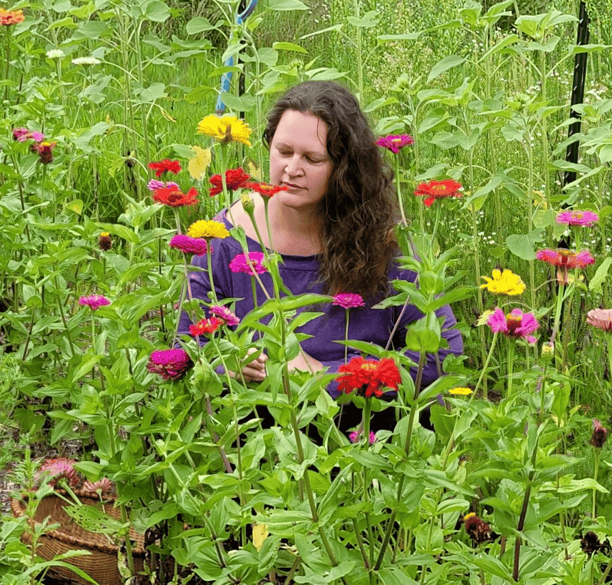 Heather Plant Holistic Wellness Coach helping women on a journey to wellness surrounded by flowers