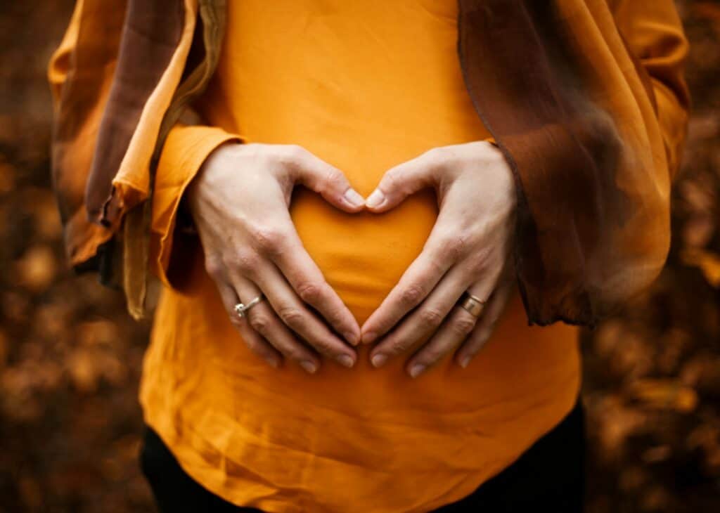 Person touching stomach denotating love for her womb with reproductive issues