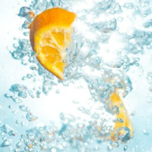 sliced orange fruits underwater showing hydration drinks