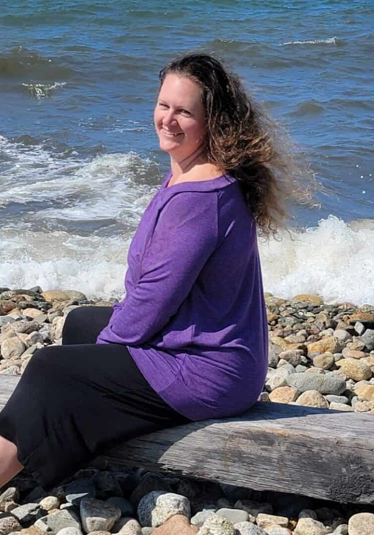 Heather Plant holistic wellness coach and herbalist helps women on journey to wellness shown in front of waves