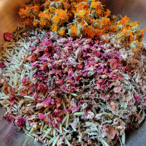 Calming herbs being used to make an herbal formula in a wellness consultation.