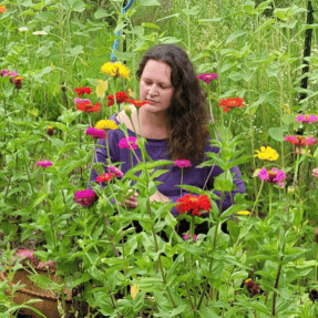 Heather Plant Holistic Wellness Coach helping women on a journey to wellness surrounded by flowers
