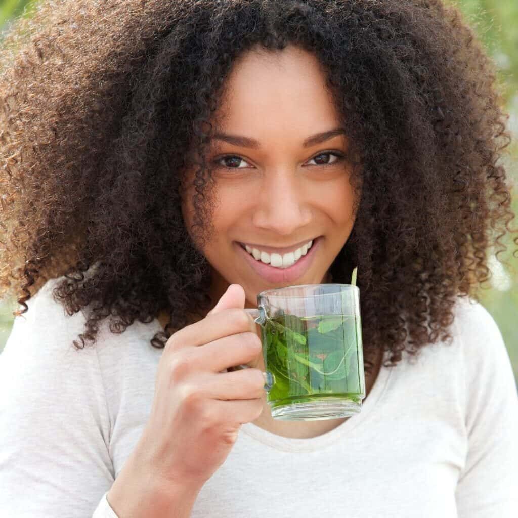 Happy calm woman drinking tea showing what you learn in The Calming Toolkit course