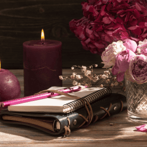 Image of journal, flowers, and candles used as a mockup for Wellness Strategy Plan consultations.