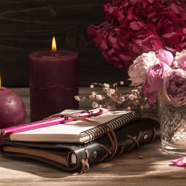 Image of journal, flowers, and candles used as a mockup for Wellness Strategy Plan consultations.