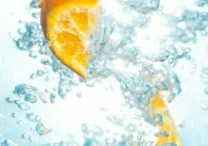 sliced orange fruits underwater showing hydration drinks